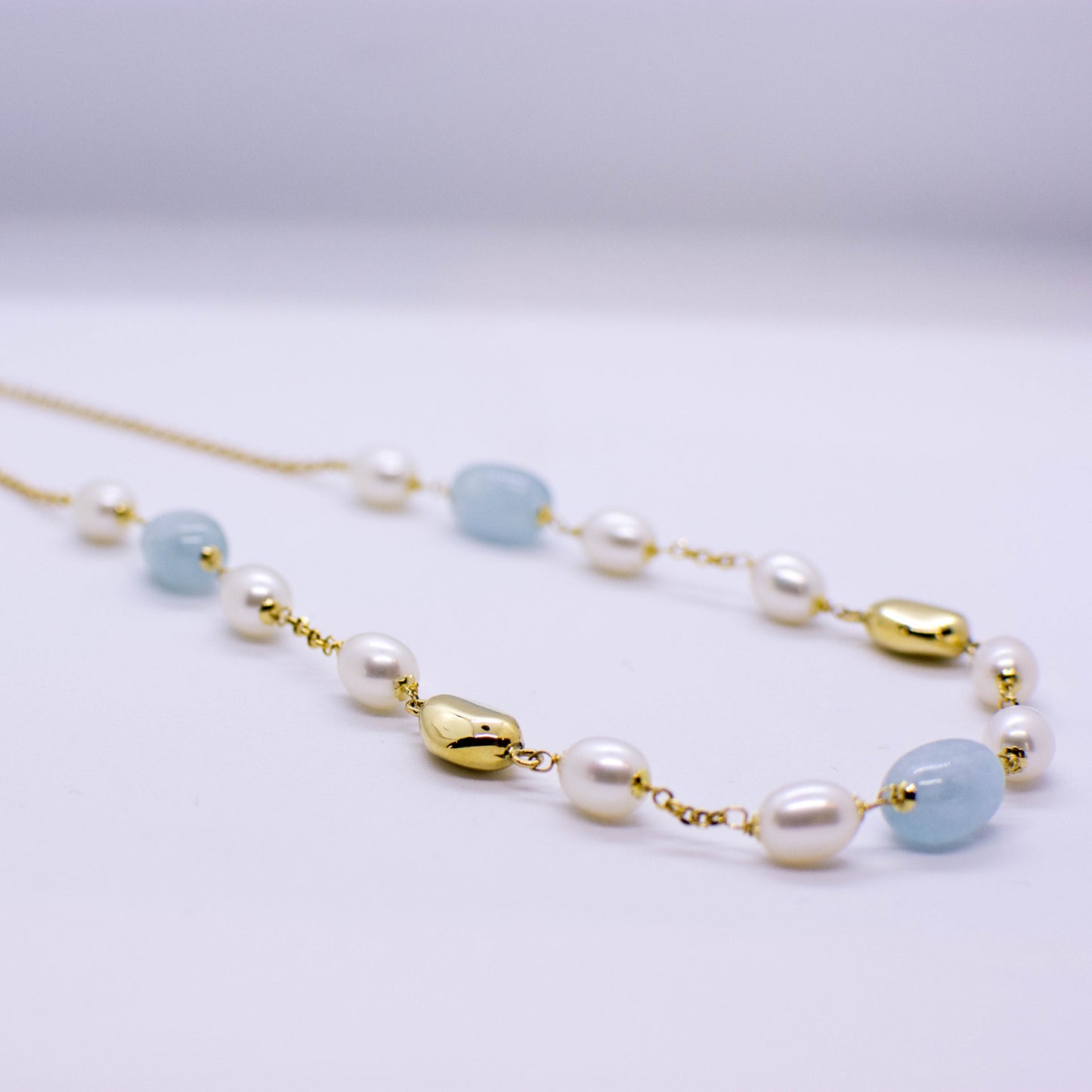 18ct Gold Silky Aquamarine and Cultured Freshwater Pearl Chain Necklace Pearl dimensions: 10mm x 8mm approximately Silky Aquamarine dimensions: 12mm x 10mm approximately 43cm long 18ct yellow gold This item can be ordered in a variety of lengths.  Please contact us for custom requirements.