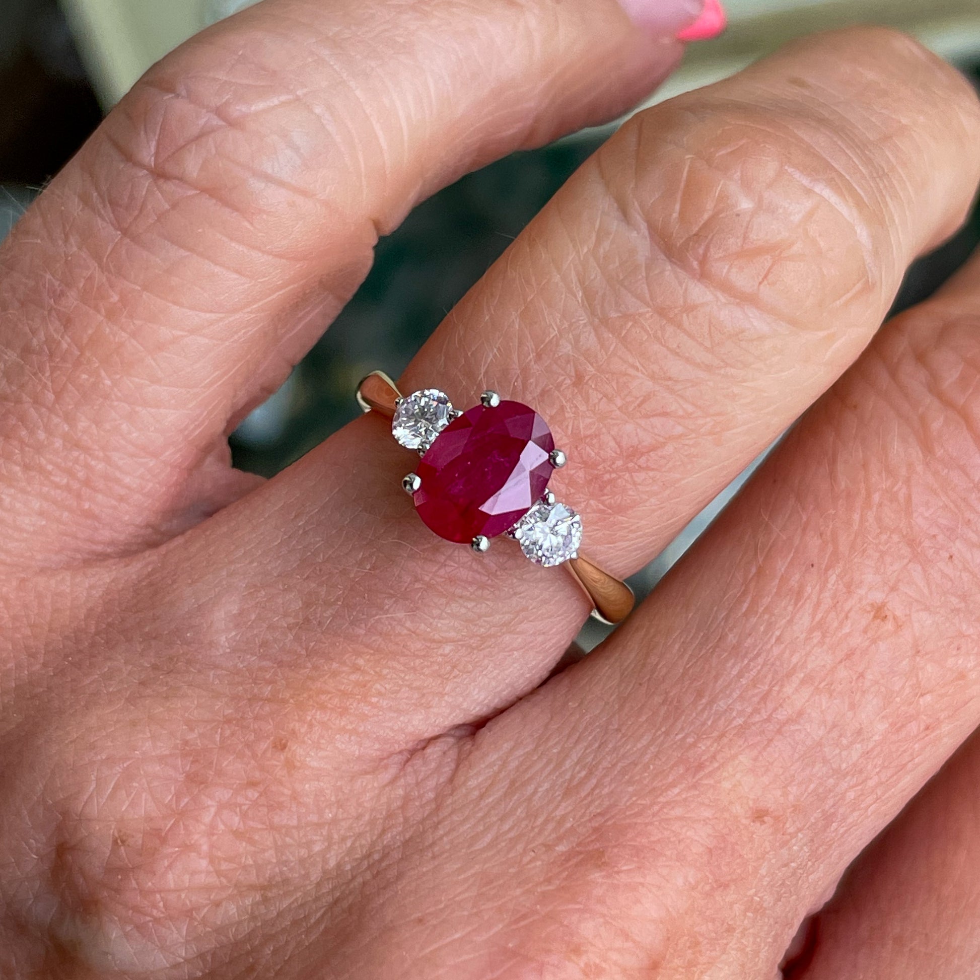 18ct yellow gold ruby and diamond trilogy.   A single oval cut ruby 1.98ct with a single diamond on either side 0.31ct in total.