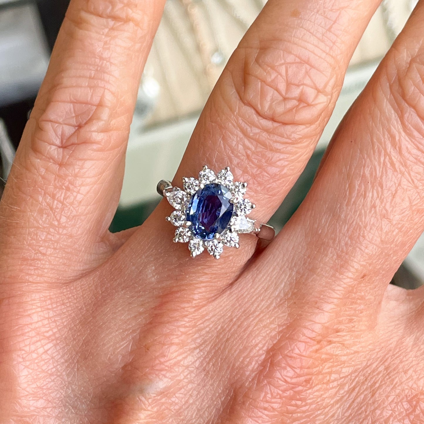 18ct White Gold Sapphire & Diamond Oval Cluster Ring   Oval Cut Sapphire: 2.04cts  Pear Cut Diamonds: 0.20ct in total  Round Brilliant Cut Diamonds: 0.52ct in total  Size N