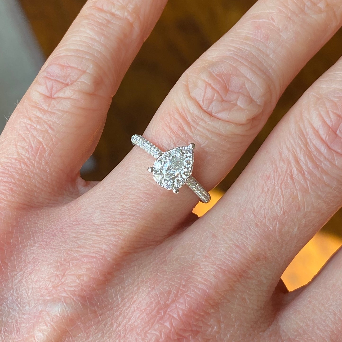 This pear cluster diamond engagement ring  is a complete classic.  Its simplicity is so romantic. The Details... One 18ct white gold diamond engagement ring.  Diamond halo cluster in an pear shape with pavé diamond-set shoulders. 0.74ct in total of diamonds.  Colour G.  Clarity VS. Centre stone: 0.22ct Melée: 0.52ct 18ct white gold.  Size M