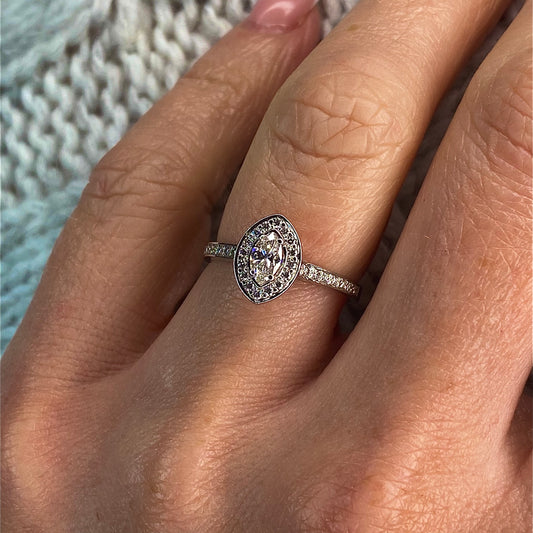 This Marquis halo diamond engagement ring  is a complete classic.  Its simplicity is so romantic.  The Details...  One 18ct white gold diamond engagement ring.  Diamond halo in a Marquis shape with diamond-set shoulders. 0.50ct in total of diamonds.  Colour GH. Clarity SI  Centre stone: 0.26ct  Melée: 0.24ct  18ct white gold.  Size N  Made in Ireland 