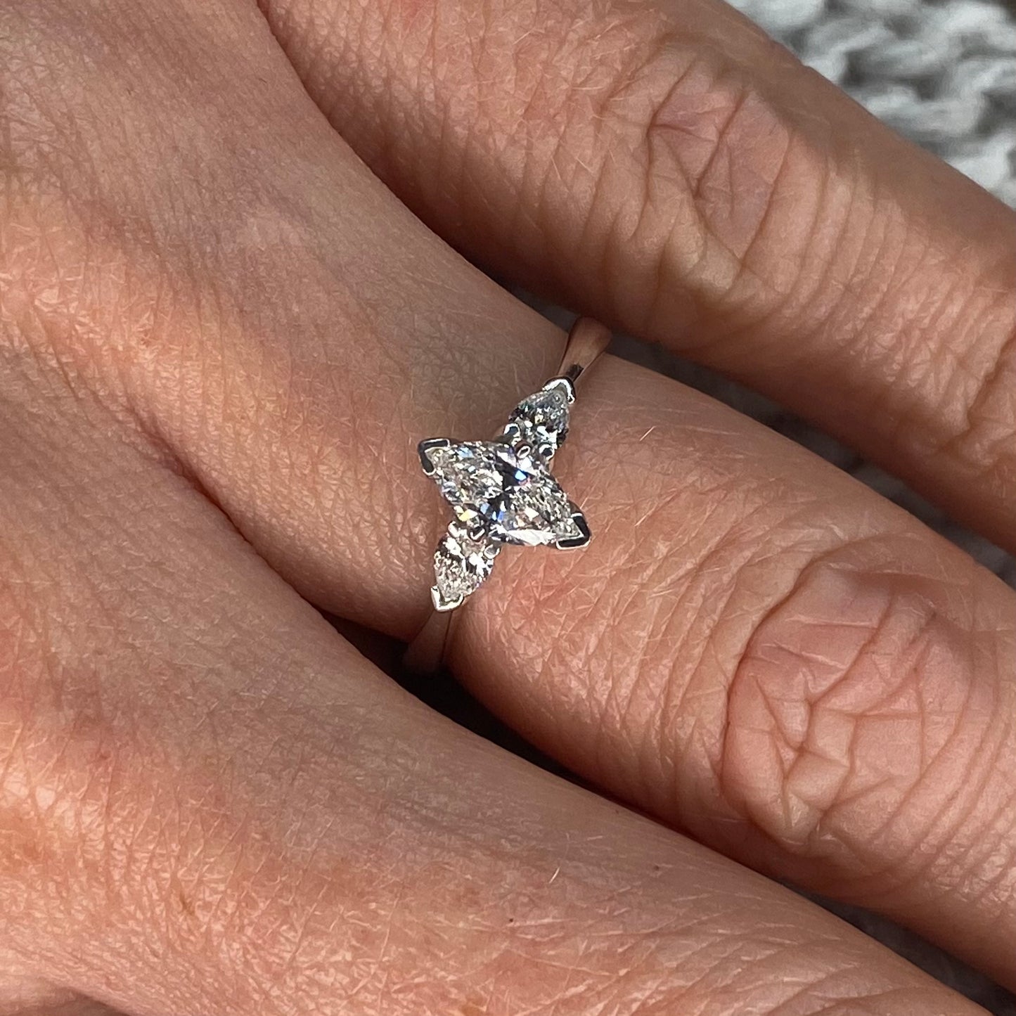 This diamond engagement ring  is a complete classic.  Its simplicity is so romantic.  The Details...  One 18ct white gold diamond engagement ring.  A Marquis cut diamond with a pear cut diamond at each side. Claw set. 0.71ct in total of diamonds.  Colour G.  Clarity SI  18ct white gold.  Size N  Made in Ireland