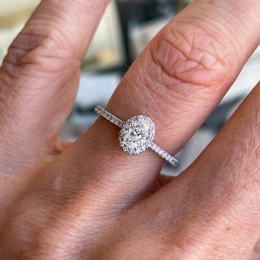 Platinum Oval Cut Solitaire Halo Diamond Ring  Centre Diamond: 0.40ct E SI1 GIA Certificate   Melée: 0.20ct