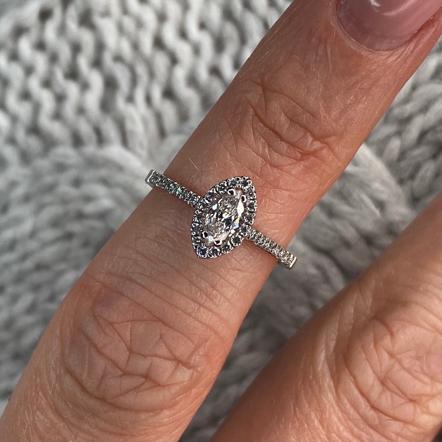 This Marquis halo diamond engagement ring  is a complete classic.  Its simplicity is so romantic.  The Details...  One 18ct white gold diamond engagement ring.  Diamond halo in a Marquis shape with diamond-set shoulders. 0.47ct in total of diamonds.  Colour GH. Clarity SI  Centre stone: 0.23ct  Melée: 0.24ct  18ct white gold.  Size L.  Made in Ireland 