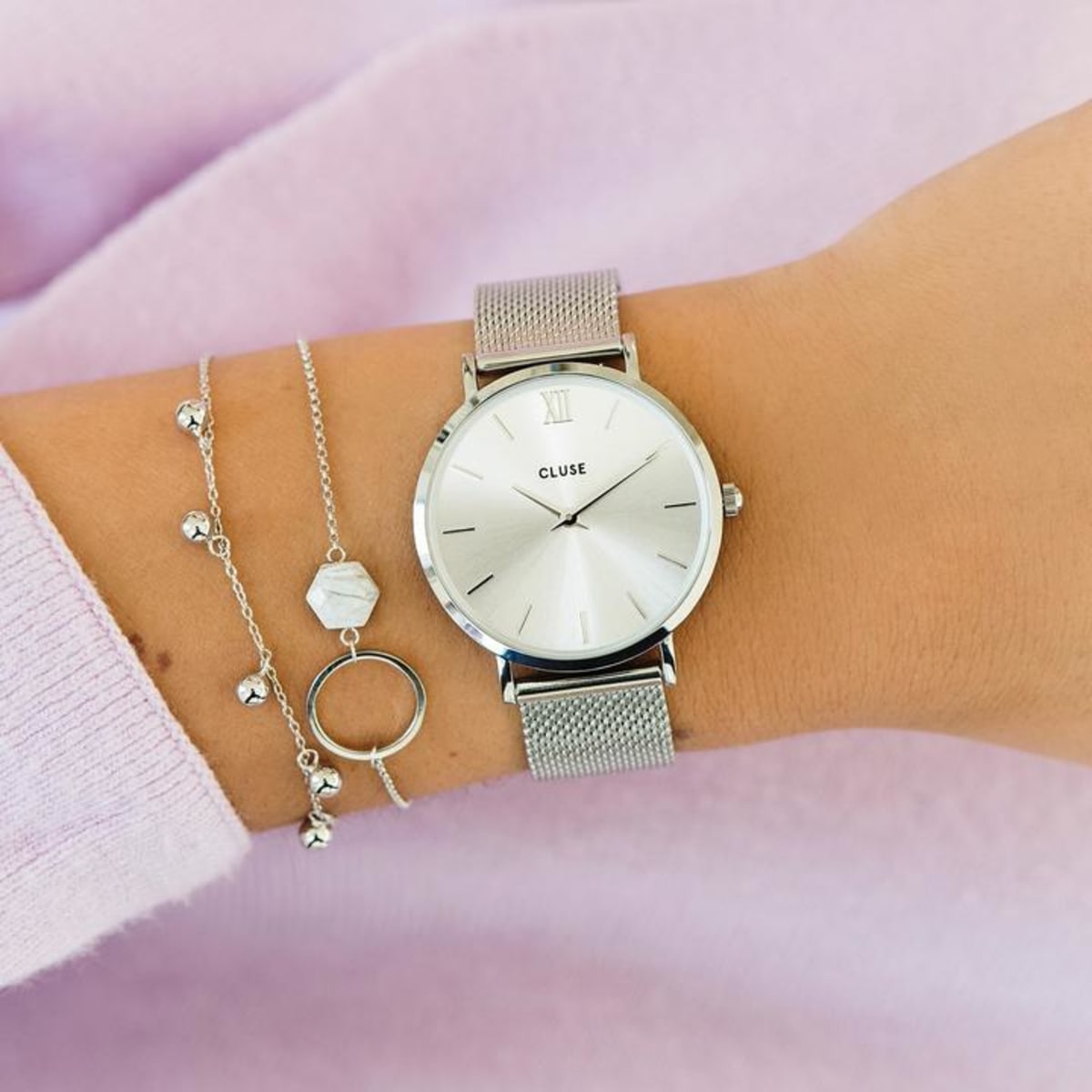 Our Minuit collection pays tribute to starry nights and elegant evening looks. The delicate design of this featherlight watch makes it the perfect accessory for a fashionable, yet subtle result. The watch features a 33 mm case, where silver is combined with a modern sunray dial and silver stainless steel mesh strap. The strap can be easily interchanged, allowing you to personalise your watch.